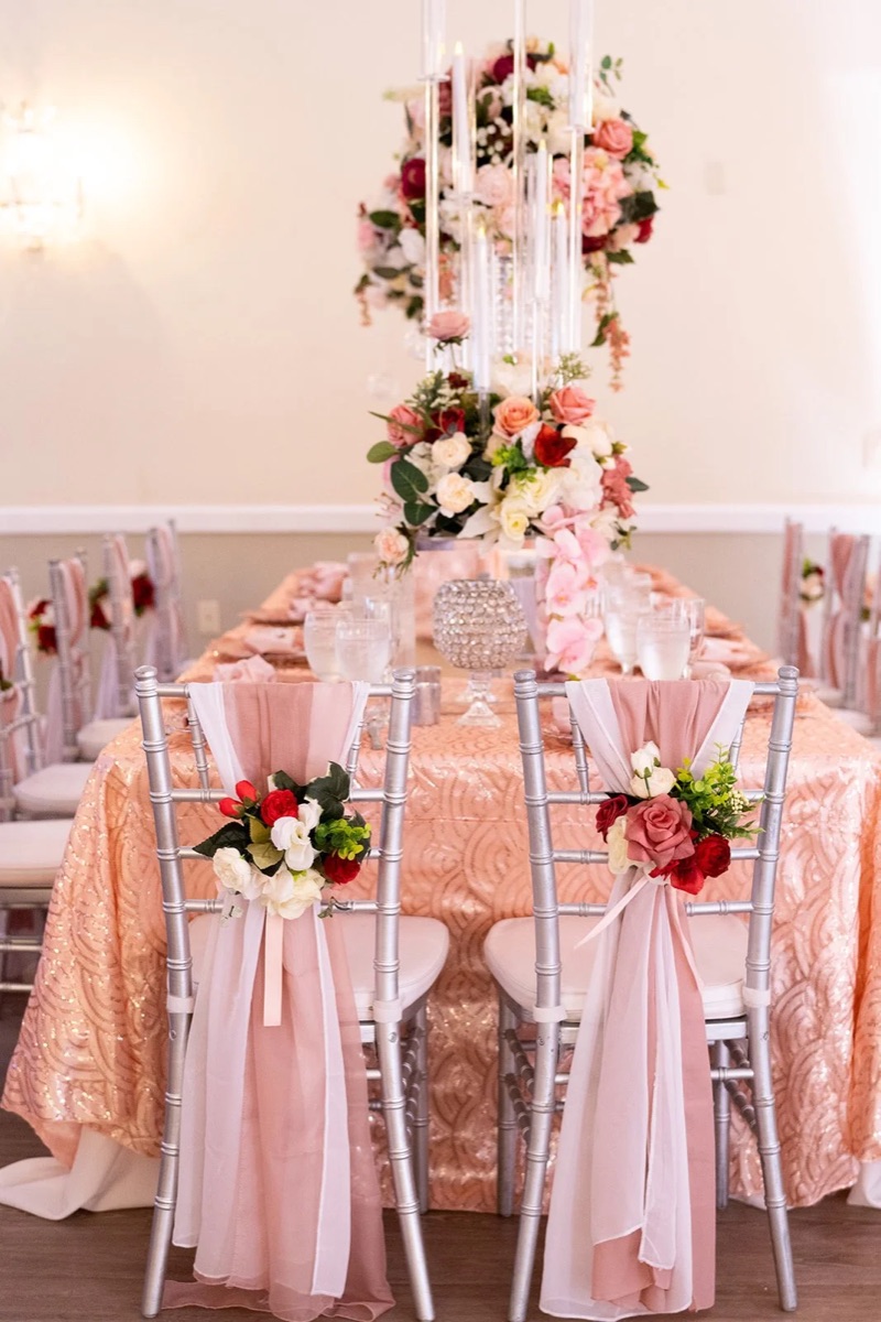 A dressed event table with layered florals